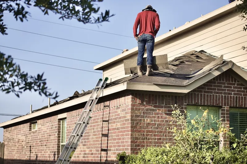 Professional roofer working on a residential roof in Woodlake